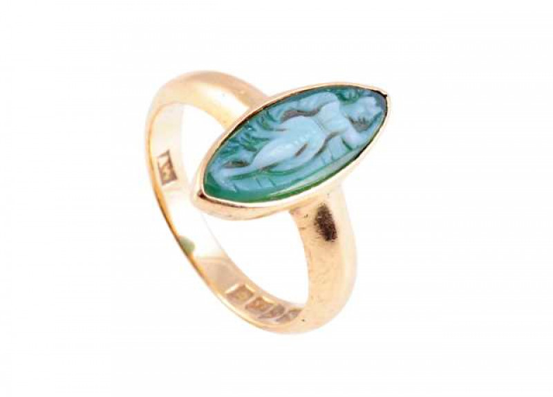 An early 19th Century cameo ring, the marquise shaped mount depicting a woman's figure, collet set in a heavy mount and band. Stamped 18. Ring size H.