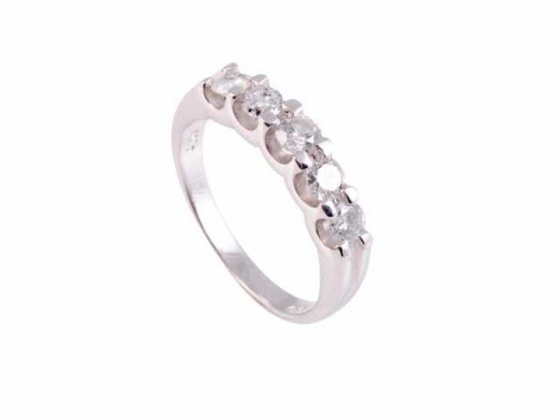 A diamond ring, the five brilliant slightly graduating cut four claw set diamonds set in open mounts between moulded shoulders on a plain band. Stamped 14K. Ring size M1/2