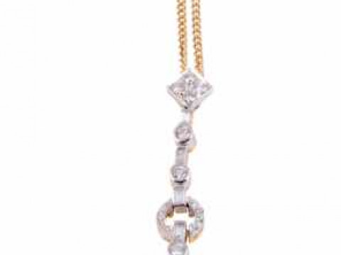 A cultured pearl and diamond pendant, the cultured pearl set to the bottom...