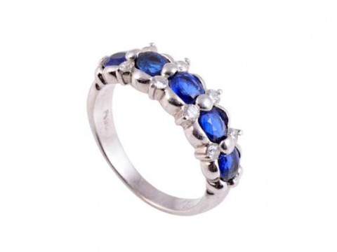 A sapphire and diamond ring, the five claw set oval mixed cut sapphires...
