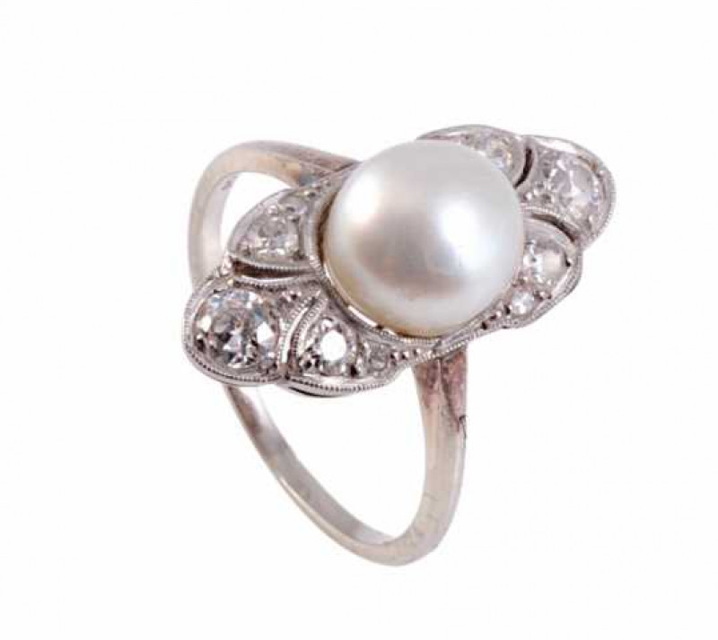 A natural pearl and diamond ring, the cultured pearl set to the centre of a marquise shaped mount, between shaped mounts each set with three round mixed cut diamonds, all set in a pierced mount between plain shoulders on a plain band. Stamped 14K. Ring si