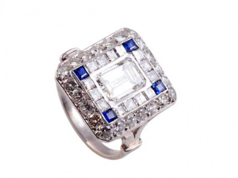 A diamond and sapphire ring, the square shaped mount set to the centre...