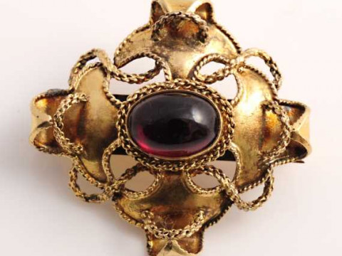 A mid Victorian garnet hair locket mourning brooch, set to the centre...
