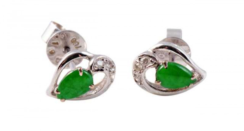 A pair of jadeite ear studs, the pear cut jadeite plaque four claw set to the centre of an open stylised heart shaped mount set with three brilliant cut diamond highlights to the top, all set in an open mount on post and scroll fittings. Scrolls stamped 7