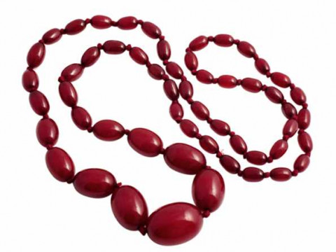 A single strand of fifty five graduating amber beads, strung simply without...