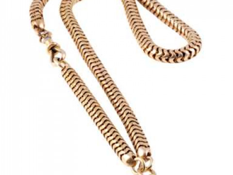 A Victorian watch chain, the thick snake link chain held by an Albert...