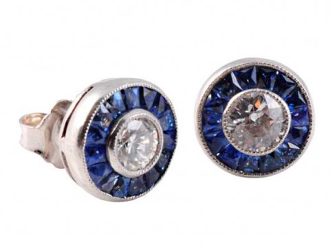 A pair of sapphire and diamond ear studs, the central brilliant cut diamond...