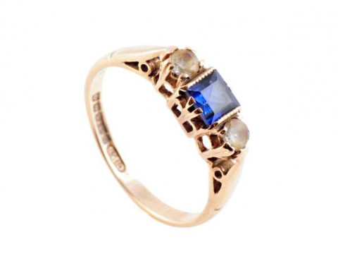 A sapphire and diamond ring, the central square cut claw set sapphire...