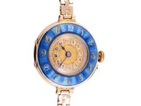 A 15 jewels enamel and gold watch, the inner dial of delicate gold coloured...