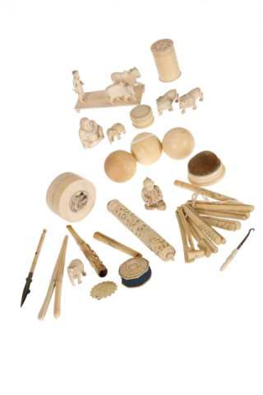 A collection of 19th and early 20th century ivory items, including teething sticks, three billiard balls, needle case and animal models.
