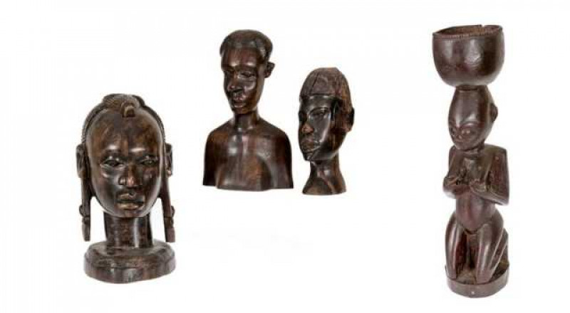 Tribal: A female fertility figure, carved on her knees, 47cm; together with a group of three carved busts. (4)
