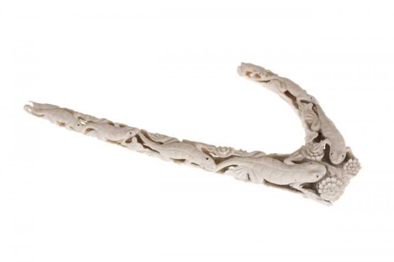 An unusual antler horn carving of lizards, circa 1900, the reptiles finely carved amidst flowerheads and with leaves to the underside. 34cm