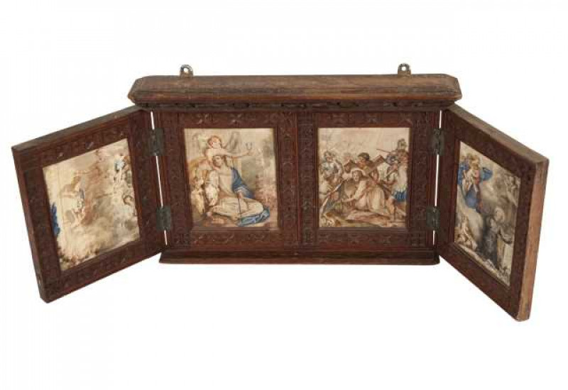 A carved oak tabernacle, the twin hinged doors opening to reveal four painted ivory panels, the oak frame carved with flowerheads. 23.5cm by 37cm