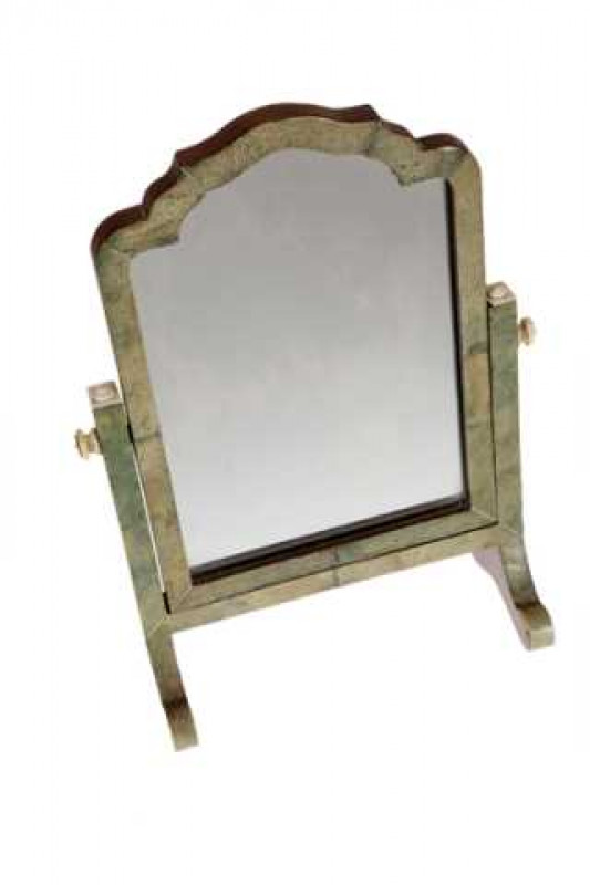 A shagreen and ivory on walnut, miniature dressing mirror, circa 1925, the shaped swing mirror raised on two cheval legs, united by a stretcher, 34cms high.