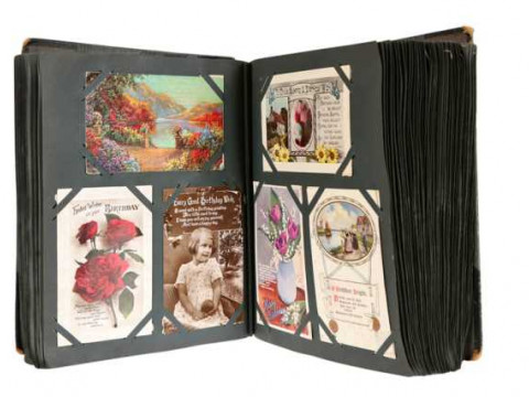 An album of approximately 450 postcards, predominantly early 20th century,...