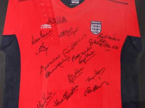 A signed replica England football shirt, signatures include Roger Hunt,...