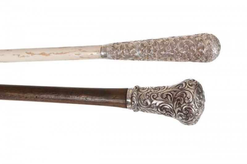 A white metal handled walking cane, engraved Sangsters Makers London, together with a white metal handled parasol, chased with scrolling foliage and flowerheads. (2) Cane 87.5cm