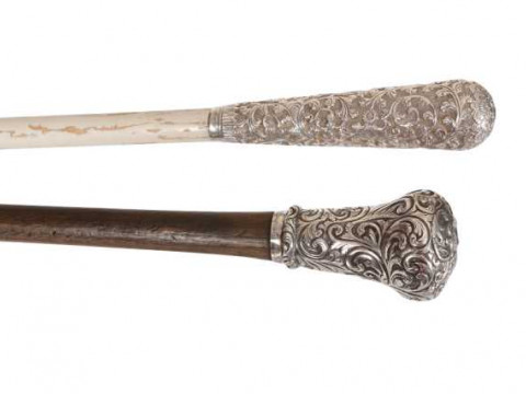 A white metal handled walking cane, engraved Sangsters Makers London,...