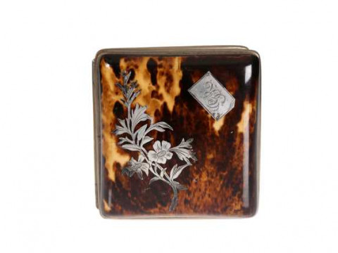 A Victorian tortoiseshell purse, the cover inlaid with a floral spray...