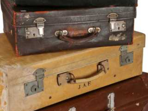 A collection of four pieces of vintage luggage, including a pigskin suitcase...