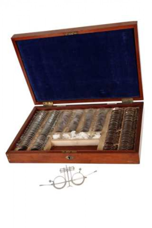 A mahogany optometrists box, circa 1890, the hinged cover with inset panel, the fitted interior with an array of lenses, ivorine labels Allen & Hanburys Ltd London. 44.5cm by 30.5cm