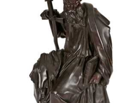 A 19th century bronze figure of St. Peter, cast sitting with a flame bladed...