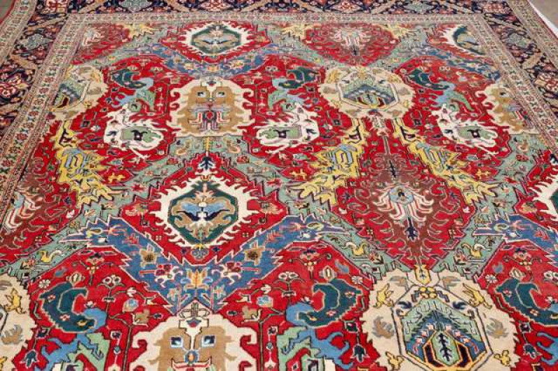 A large Tabriz carpet. 404cm by 282cm