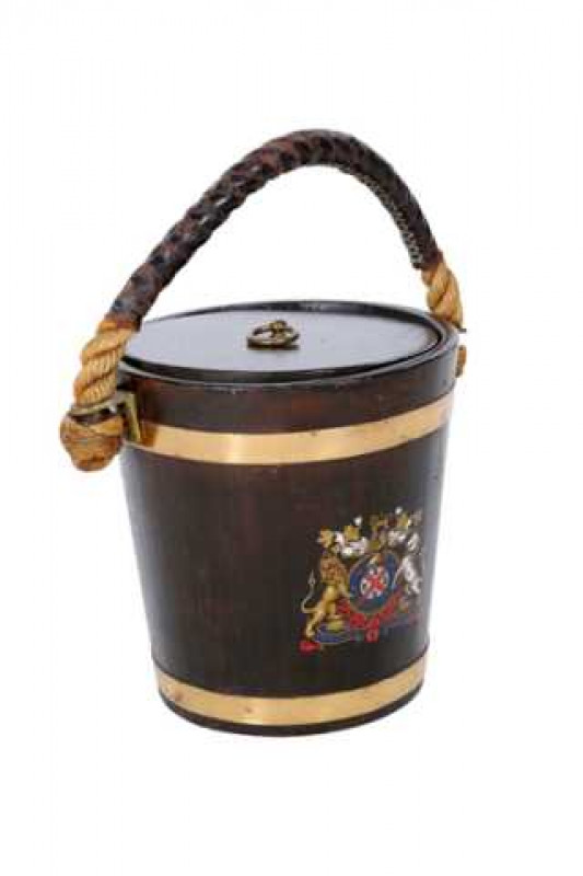 A brass bound fire bucket, the coopered pail with circular cover and tin liner, rope handle and painted with a coat of arms. 31cm