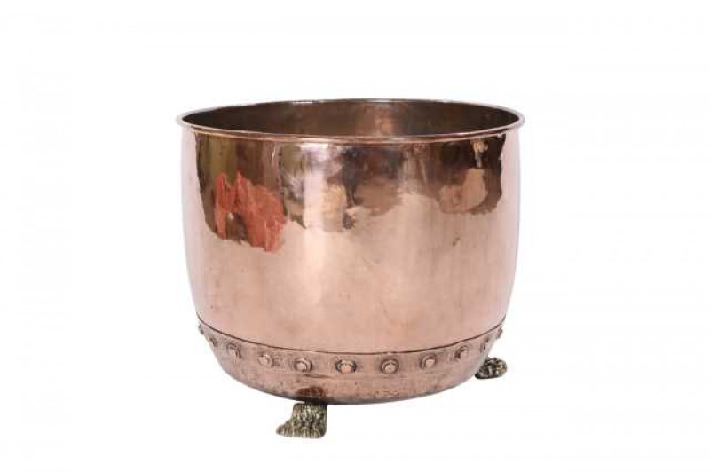 A late Victorian polished copper and brass log bin, with 'belted' band and paw feet. 38cmn by 48cm