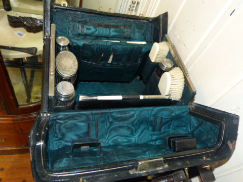 Gladstone travelling bag with silver mounted toilet jars and ivory brushes...