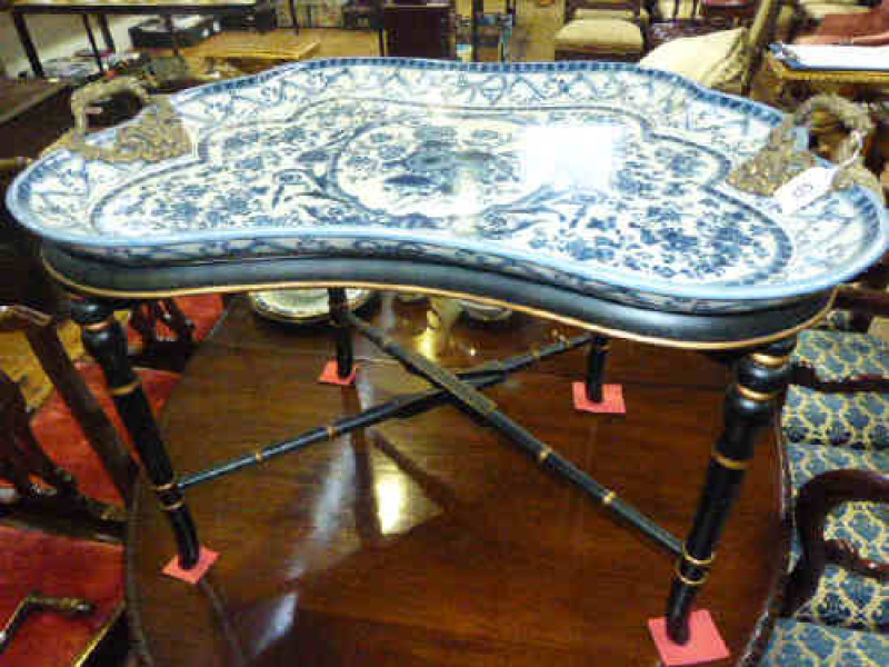 Large shaped blue and white tray with ormolu handles, raised on ebonised and gilt folding wood base