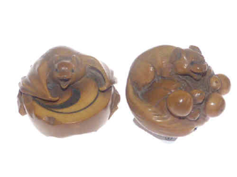 Two Japanese carved nuts each signed to the base
