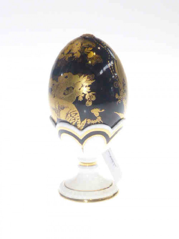 Royal Crown Derby egg with gilt painted design on black ground with white and gilt decorated cup