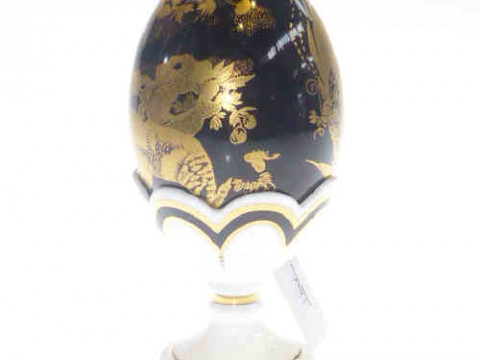 Royal Crown Derby egg with gilt painted design on black ground with white...