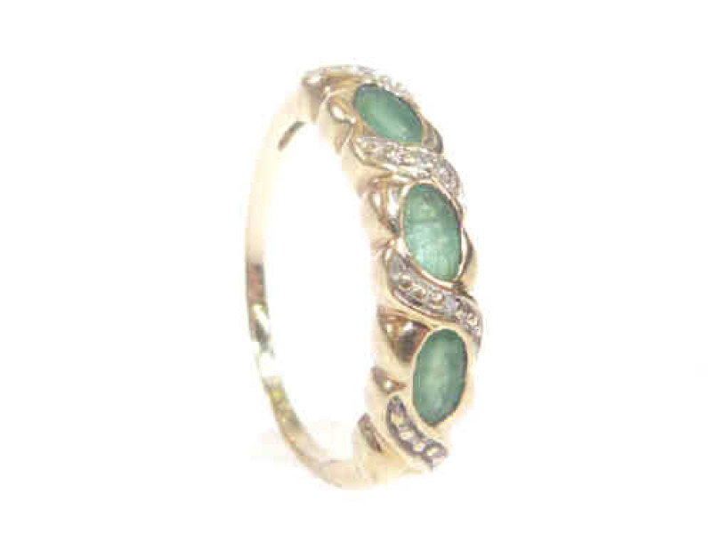 Yellow metal ring set with three green stones, size P