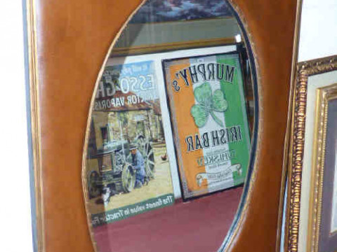 Contemporary leather mounted mirror with oval plate