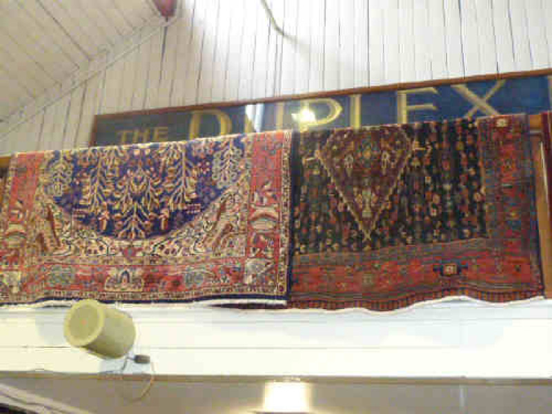 Blue ground Tree of Life rug 3.05 x 1.55 and a black ground Persian design rug 2.95 x 1.48 (2)