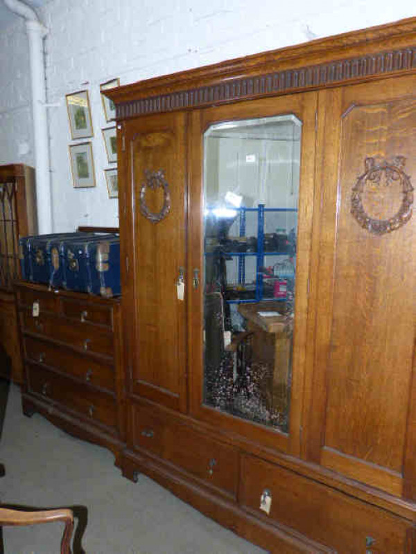1920's oak mirror door wardrobe and five drawer chest and bed head, two framed wall mirrors and travelling trunk (6)