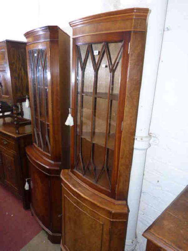 Two similar walnut and mahogany glazed door double corner cabinets