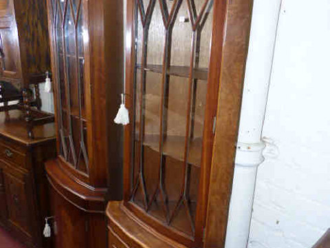 Two similar walnut and mahogany glazed door double corner cabinets
