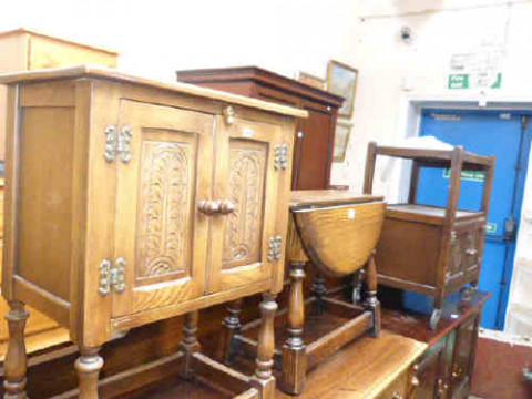Carved oak two door pedestal cupboard, oak drop leaf coffee table and...