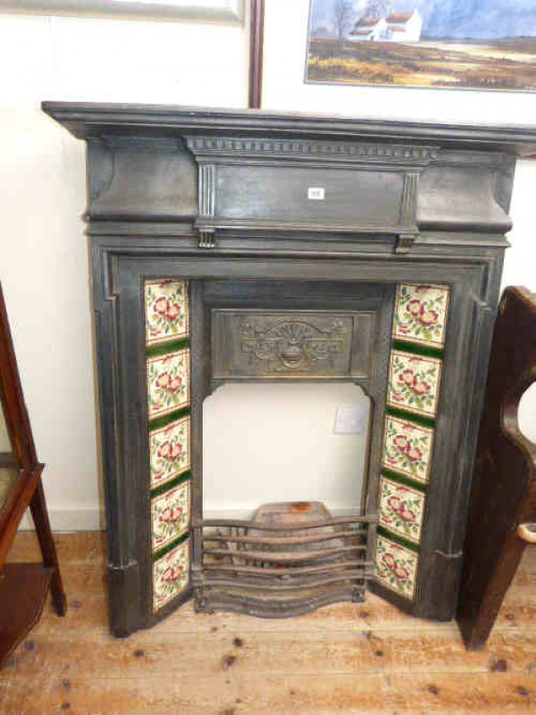 Victorian style cast metal living room fireplace with floral design tiles