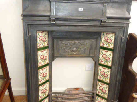 Victorian style cast metal living room fireplace with floral design tiles