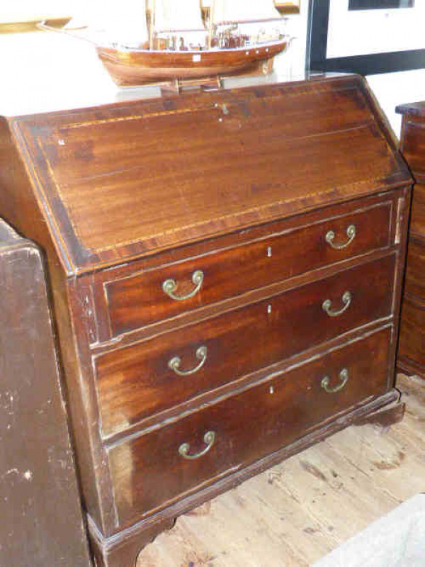 Georgian inlaid mahogany bureau, the fall front above three graduated drawers on bracket feet