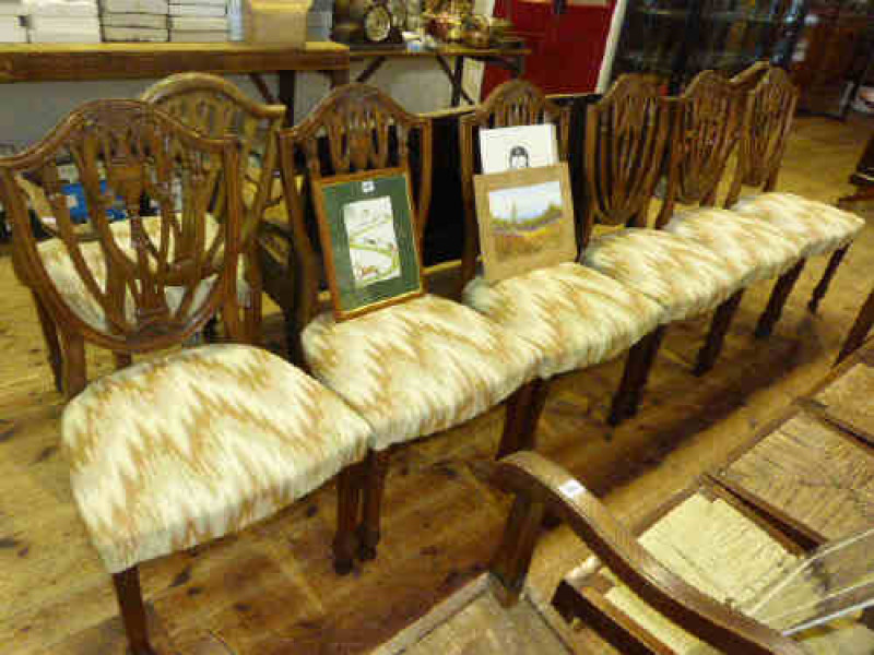 A set of eight Hepplewhite style shield back mahogany dining chairs, to include two carvers and six single chairs