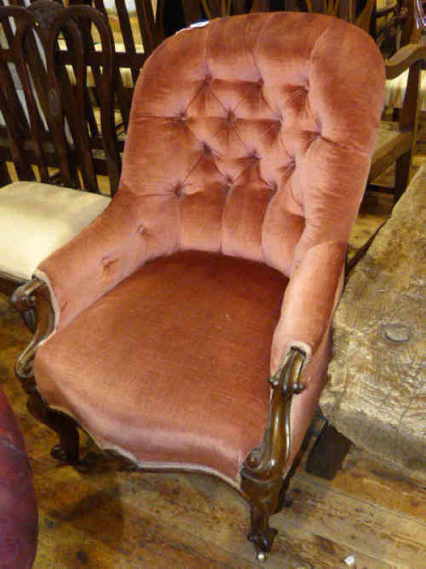 Victorian carved walnut ladies chair with serpentine front seat in rose pink buttoned fabric