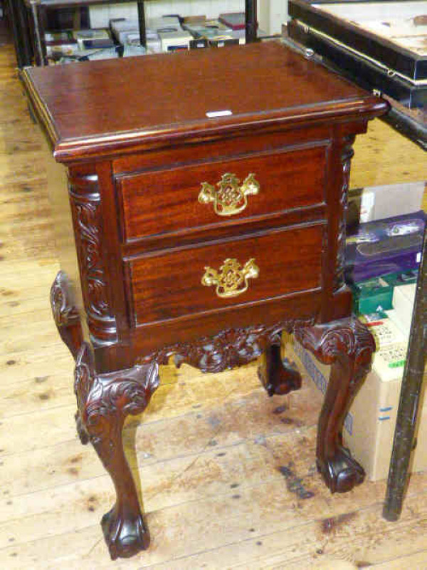 Pair of carved mahogany two drawer pedestal chest on ball and claw feet