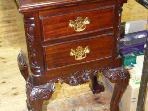 Pair of carved mahogany two drawer pedestal chest on ball and claw feet