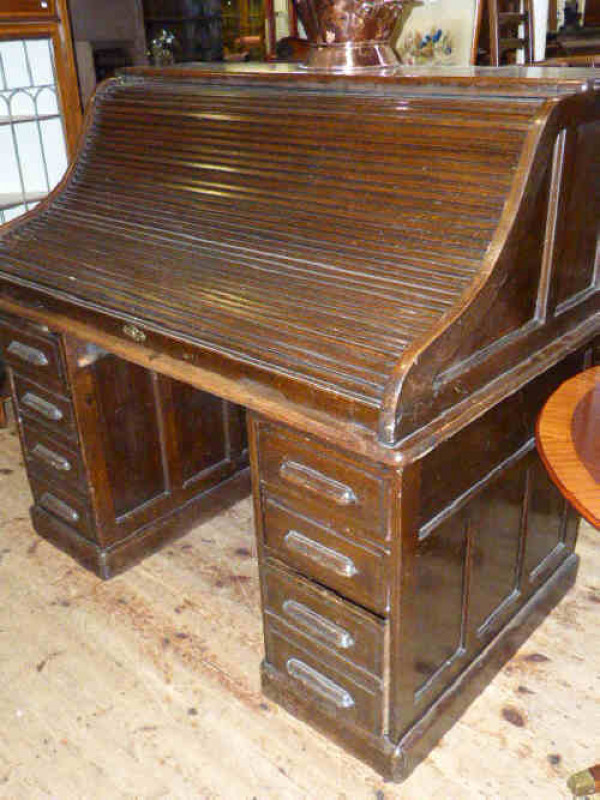 Oak S shaped double pedestal roll top desk