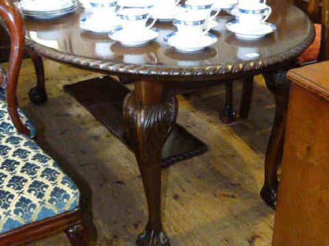 Oval mahogany Chippendale style extending dining table and two leaves...